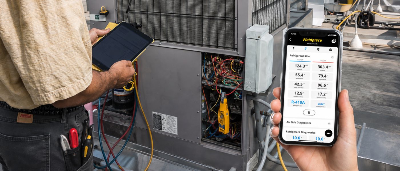 Field technician using the Fieldpiece Job Link System at an HVAC unit